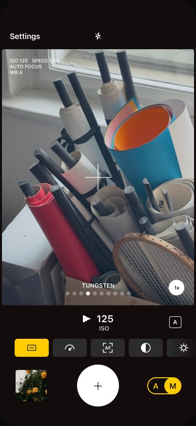 Ordinary camera screen — rolls of paper on a workbench, film look Tungsten
